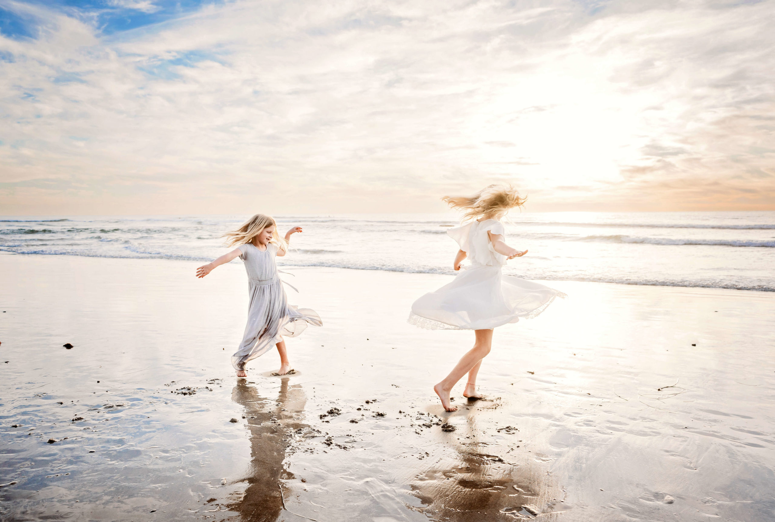 Carlsbad family photography session at the beach with two girls playing