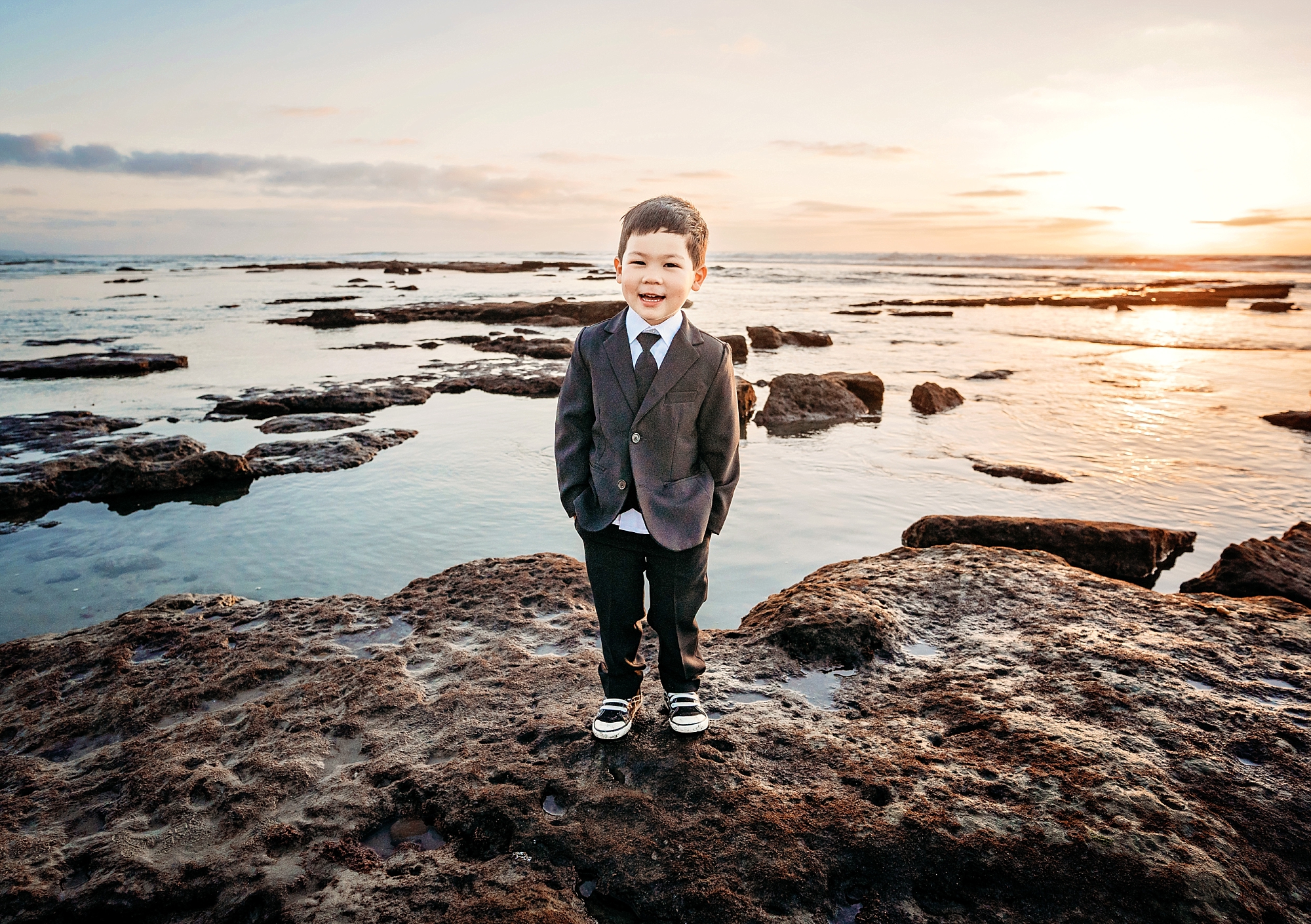 San Diego boy in suit at the beach during family photos by San Diego photographer Tristan Quigley