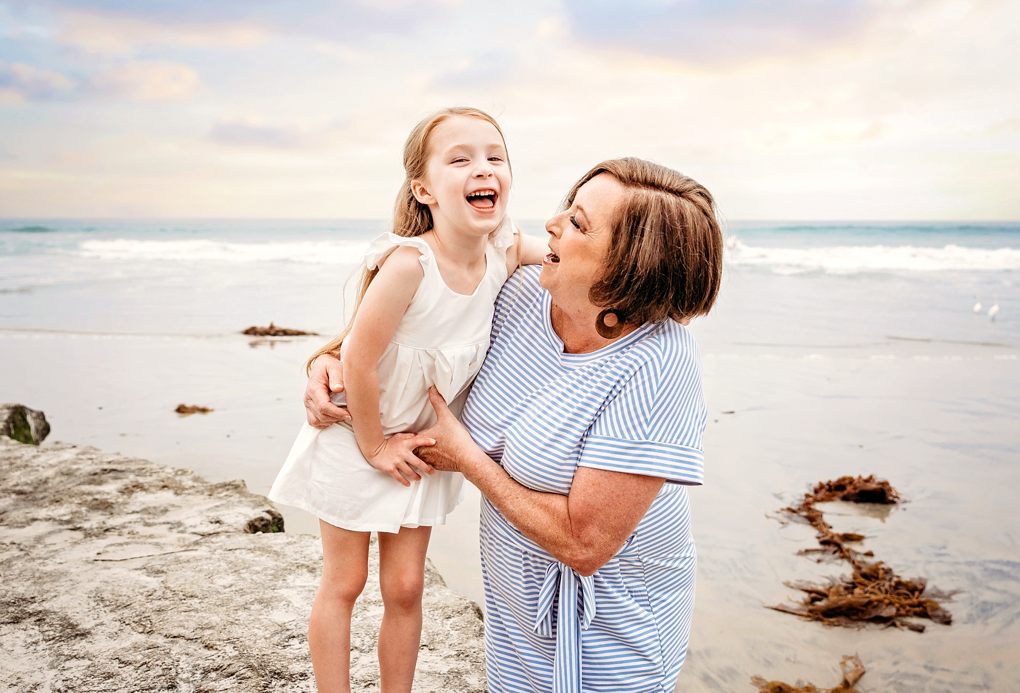 professional photos with grandma and granddaughter at San Diego area beach