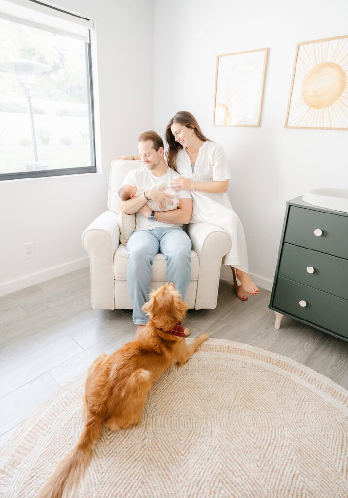 san diego lifestyle newborn photographer Tristan Quigley captures a new family of three with their dog in the nursery