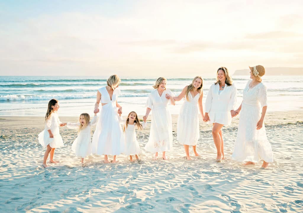What to Wear for Spring Family Photos: The Perfect Outfits 6 a family dressed in all neutrals and whites for family photos on the beach in san diego