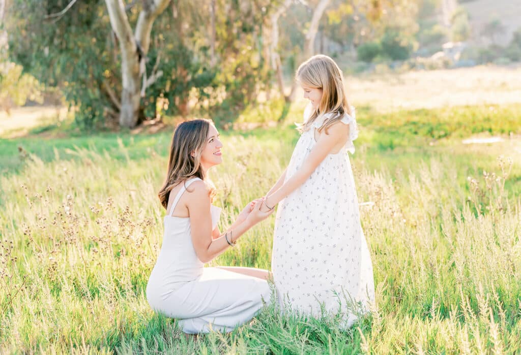 What to Wear for Spring Family Photos: The Perfect Outfits 1 a mom & her daughter wearing beautiful dresses for their spring family photo session in san diego
