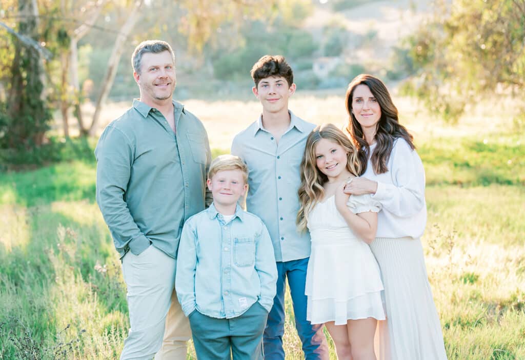 Family on a San Diego trail wearing warm neutral layers for fall family photos